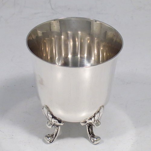 An Antique Edwardian Sterling Silver egg cup, having a plain round body with tapering sides, sitting on four cast foliate feet. Made by Charles Clement Pilling of Sheffield in 1907. The dimensions of this fine hand-made silver egg cup are height 5 cms (2 inches), diameter 4.5 cms (1.75 inches), and it weighs approx. 50g (1.6 troy ounces).