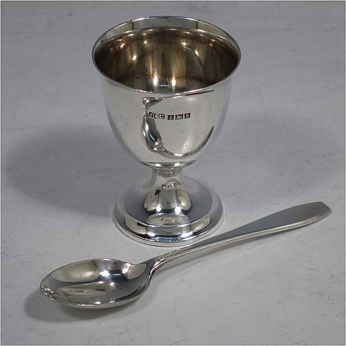 A Sterling Silver christening set, having a plain round egg cup, and a plain pattern spoon. All fitted in their original cream satin and blue velvet-lined presentation box. Made in Birmingham in 1964. The dimensions of this fine hand-made silver christening set are length of spoon 11 cms (4.3 inches), height of egg cup 6.5 cms (2.5 inches), and the total weight is approx. 50g (1.6 troy ounce).    