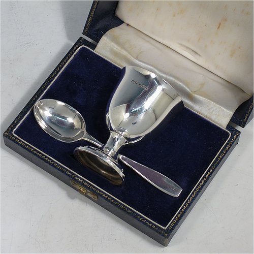 A Sterling Silver christening set, having a plain round egg cup, and a plain pattern spoon. All fitted in their original cream satin and blue velvet-lined presentation box. Made in Birmingham in 1964. The dimensions of this fine hand-made silver christening set are length of spoon 11 cms (4.3 inches), height of egg cup 6.5 cms (2.5 inches), and the total weight is approx. 50g (1.6 troy ounce).    