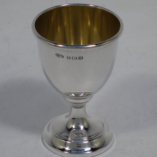 A handsome Sterling Silver egg cup and spoon, having a plain round egg cup with a gold-gilt interior, and a plain Old English pattern spoon. All fitted in their original cream satin and black velvet-lined presentation box. Made by Arthur Price of Birmingham in 1936. The dimensions of this fine hand-made silver egg cup and spoon are length of spoon 11 cms (4.3 inches), height of egg cup 6.5 cms (2.5 inches), and the total weight is approx. 28g (0.9 troy ounce).   