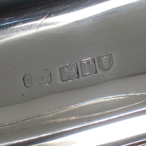 A handsome Antique Sterling Silver entree dish with cover, having a rectangular body with rounded corners and applied straight gadroon borders, a cast bayonet-fit removable asparagus style loop handle, and sitting on a flat base. Made by Carrington and Co., of London in 1912. The dimensions of this fine hand-made antique silver entree dish and cover are length 28 cms (11 inches), height including handle 11 cms (4.5 inches), width 20 cms (8 inches), and with a total weight of approx. 1,540g (49.7 troy ounces).