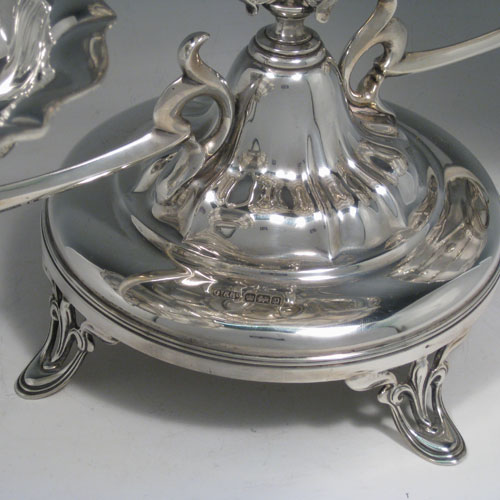 Antique Edwardian sterling silver table epergne center-piece, having an Art Nouveau style, with one central large dish and two smaller dishes resting on side arms, and all sitting on a pedestal base with four pierced feet. Made by Olivant and Botsford of Sheffield in 1907. Height 30 cms (11.75 inches), width 50 cms (19.75 inches), depth 26 cms (10.25 inches). Total weight approx. 2,058 (66.4 troy ounces).