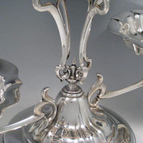Antique Edwardian sterling silver table epergne center-piece, having an Art Nouveau style, with one central large dish and two smaller dishes resting on side arms, and all sitting on a pedestal base with four pierced feet. Made by Olivant and Botsford of Sheffield in 1907. Height 30 cms (11.75 inches), width 50 cms (19.75 inches), depth 26 cms (10.25 inches). Total weight approx. 2,058 (66.4 troy ounces).