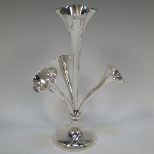 A very pretty Antique Edwardian Sterling Silver Art Nouveau flower vase epergne center-piece, having three removable flower vases and a central larger vase, all with fluted bodies and bead-edged borders, and all sitting on a plain round pedestal foot. All made by John Grinsell of Birmingham in 1905. The dimensions of this fine hand-made antique silver flower epergne are height 24 cms (9.5 inches), and spread across vases 15 cms (6 inches).  
