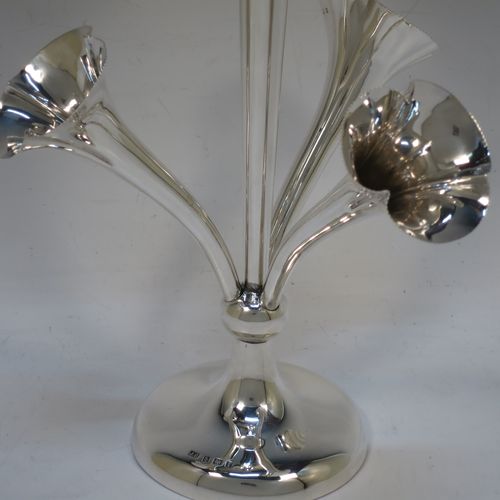 A very pretty Antique Edwardian Sterling Silver Art Nouveau flower vase epergne center-piece, having three removable flower vases and a central larger vase, all with fluted bodies and bead-edged borders, and all sitting on a plain round pedestal foot. All made by John Grinsell of Birmingham in 1905. The dimensions of this fine hand-made antique silver flower epergne are height 24 cms (9.5 inches), and spread across vases 15 cms (6 inches).  