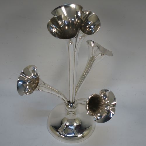 A very pretty Antique Edwardian Sterling Silver Art Nouveau flower vase epergne center-piece, having three removable flower vases and a central larger vase, all with fluted bodies and bead-edged borders, and all sitting on a plain round pedestal foot. All made by John Grinsell of Birmingham in 1905. The dimensions of this fine hand-made antique silver flower epergne are height 24 cms (9.5 inches), and spread across vases 15 cms (6 inches).  