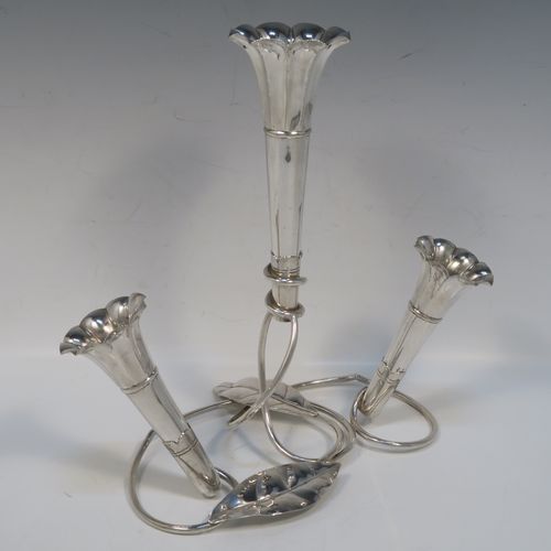 A very pretty Antique Victorian Silver Plated Art Nouveau flower vase epergne center-piece, having three removable flower vases, with a central larger vase, all sitting on a base with wire-work tendrils and leaves. This beautiful centre-piece flower epergne was made in ca. 1890 by Martin Hall and Co., of Sheffield, England. The dimensions of this fine hand-made silver-plated flower epergne are height 25 cms (9.25 inches), and spread across base 20 cms (8 inches).   