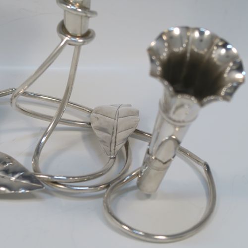 A very pretty Antique Victorian Silver Plated Art Nouveau flower vase epergne center-piece, having three removable flower vases, with a central larger vase, all sitting on a base with wire-work tendrils and leaves. This beautiful centre-piece flower epergne was made in ca. 1890 by Martin Hall and Co., of Sheffield, England. The dimensions of this fine hand-made silver-plated flower epergne are height 25 cms (9.25 inches), and spread across base 20 cms (8 inches).   