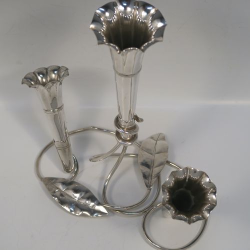 A very pretty Antique Victorian Silver Plated Art Nouveau flower vase epergne center-piece, having three removable flower vases, with a central larger vase, all sitting on a base with wire-work tendrils and leaves. This beautiful centre-piece flower epergne was made in ca. 1890 by Martin Hall and Co., of Sheffield, England. The dimensions of this fine hand-made silver-plated flower epergne are height 25 cms (9.25 inches), and spread across base 20 cms (8 inches).   
