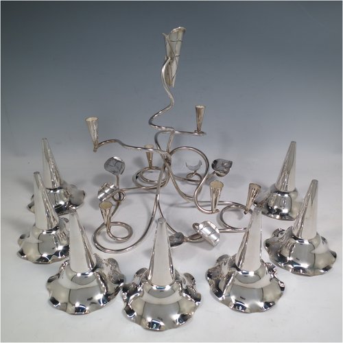 An Antique Victorian silver plated Art Nouveau flower vase epergne center-piece, having seven removable flower vases, with a tendril and leaf style body. All made in ca. 1890. The dimensions of this fine hand-made silver-plated flower epergne are height 30.5 cms (12 inches), and spread across vases 33 cms (13 inches).