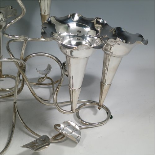 An Antique Victorian silver plated Art Nouveau flower vase epergne center-piece, having seven removable flower vases, with a tendril and leaf style body. All made in ca. 1890. The dimensions of this fine hand-made silver-plated flower epergne are height 30.5 cms (12 inches), and spread across vases 33 cms (13 inches).