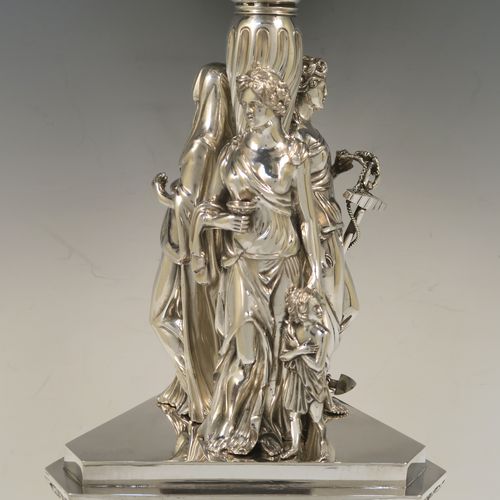 A beautiful and impressive Scottish Antique Victorian Sterling Silver epergne centre-piece, having a top bowl with hand-chased floral, scroll and figural decoration, above a central area consisting of three separate cast caryatid female figures, all sitting on a triangular plinth with tapering sides and applied figural and scroll motifs. This wonderful antique silver centrepiece epergne was made by Marshall and Sons of Edinburgh, Scotland, in 1837. The dimensions of this fine hand-made silver centre-piece are height 47.5 cms (18.75 cms), diameter of bowl 28 cms (11 inches), and it weighs approx. 3,680g (118.7 troy ounces).