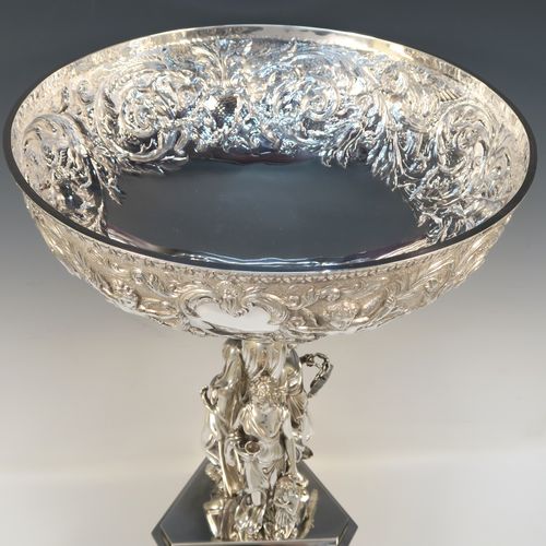 A beautiful and impressive Scottish Antique Victorian Sterling Silver epergne centre-piece, having a top bowl with hand-chased floral, scroll and figural decoration, above a central area consisting of three separate cast caryatid female figures, all sitting on a triangular plinth with tapering sides and applied figural and scroll motifs. This wonderful antique silver centrepiece epergne was made by Marshall and Sons of Edinburgh, Scotland, in 1837. The dimensions of this fine hand-made silver centre-piece are height 47.5 cms (18.75 cms), diameter of bowl 28 cms (11 inches), and it weighs approx. 3,680g (118.7 troy ounces).