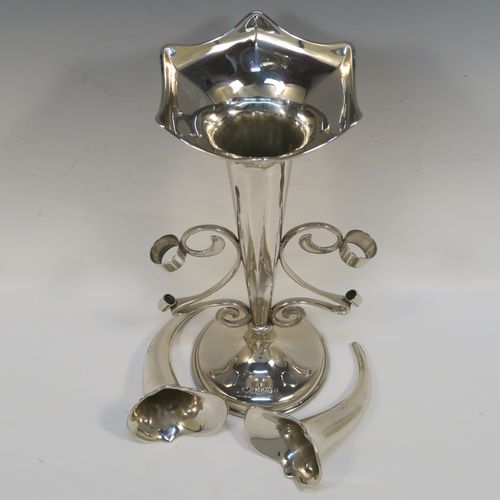 A pretty Antique Sterling Silver flower vase epergne center-piece in a plain round style, having two removable side flower vases connected to a central larger vase with scroll wire-work, and all sitting on a plain round pedestal base. This beautiful antique silver flower epergne was made by Joseph Gloster of Birmingham in 1913. The dimensions of this fine hand-made sterling silver flower centre-piece epergne are height 26 cms (10.25 inches), spread across vases 25.5 cms (10 inches), and it weighs approx. 465g (15 troy ounces).