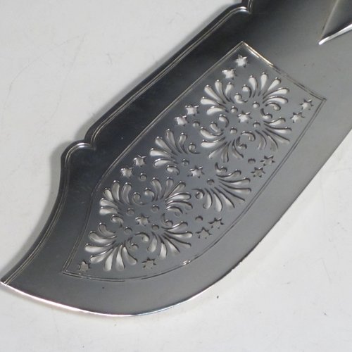 Antique Georgian sterling silver fish server slice, having a plain Fiddle pattern handle, a hand-pierced asymmetrical and curved blade, and a hand-engraved reeded border. Made by William Eley of London in 1830. The dimensions of this fine hand-made silver fish serving slice are length 30 cms (11.75 inches), and it weighs approx. 119g (3.8 troy ounces).   