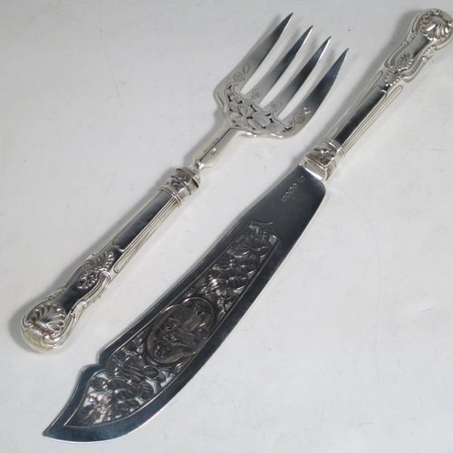 Antique early Victorian sterling silver fish serving knife and fork set, having filled handles in the double-struck Kings pattern, hand-pierced and hand-engraved blade and tines with floral and leaf decoration, the blade with a cartouche engraved with a lady holding a tray of fish. Made by Francis Higgins of London in 1849. The dimensions of this fine hand-made silver fish serving set are length of knife 33 cms (13 inches), and length of fork 24 cms (9.5 inches). Please note that the handles have a number of small dents, but are otherwise in very good condition.