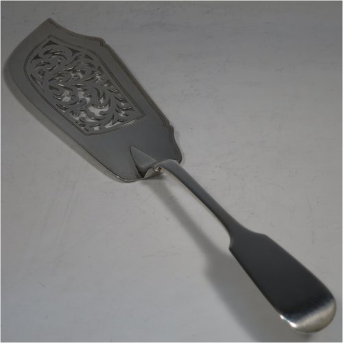 Antique Georgian sterling silver fish server slice, having a plain Fiddle pattern handle, a hand-pierced asymmetrical and curved blade, and a hand-engraved reeded border. Made by William Eley of London in 1838. The dimensions of this fine hand-made silver fish serving slice are length 30 cms (11.75 inches), and it weighs approx. 140g (4.5 troy ounces).   