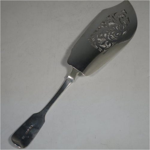 Antique Georgian sterling silver fish server slice, having a plain Fiddle pattern handle, a hand-pierced asymmetrical and curved blade, and a hand-engraved reeded border. Made by William Eley of London in 1838. The dimensions of this fine hand-made silver fish serving slice are length 30 cms (11.75 inches), and it weighs approx. 140g (4.5 troy ounces).