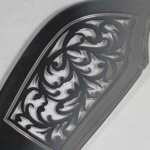 Antique Georgian sterling silver fish server slice, having a plain Fiddle pattern handle, a hand-pierced asymmetrical and curved blade, and a hand-engraved reeded border. Made by William Eley of London in 1838. The dimensions of this fine hand-made silver fish serving slice are length 30 cms (11.75 inches), and it weighs approx. 140g (4.5 troy ounces).
