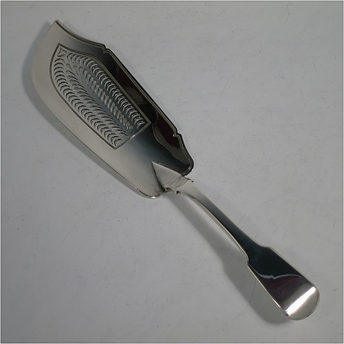 An Antique Georgian Sterling Silver fish server slice, in the plain Fiddle pattern, having a hand-pierced asymmetrical and curved blade, and a hand-engraved reeded border. Made by William Knight of London in 1825. The dimensions of this fine hand-made antique silver fish serving slice are length 30 cms (11.75 inches), and it weighs approx. 154g (5 troy ounces). 
