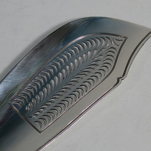 An Antique Georgian Sterling Silver fish server slice, in the plain Fiddle pattern, having a hand-pierced asymmetrical and curved blade, and a hand-engraved reeded border. Made by William Knight of London in 1825. The dimensions of this fine hand-made antique silver fish serving slice are length 30 cms (11.75 inches), and it weighs approx. 154g (5 troy ounces).