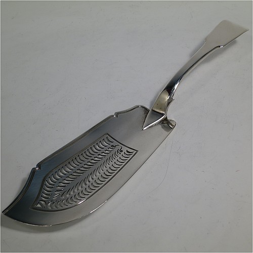 An Antique Georgian Sterling Silver fish server slice, in the plain Fiddle pattern, having a hand-pierced asymmetrical and curved blade, and a hand-engraved reeded border. Made by William Knight of London in 1825. The dimensions of this fine hand-made antique silver fish serving slice are length 30 cms (11.75 inches), and it weighs approx. 154g (5 troy ounces).