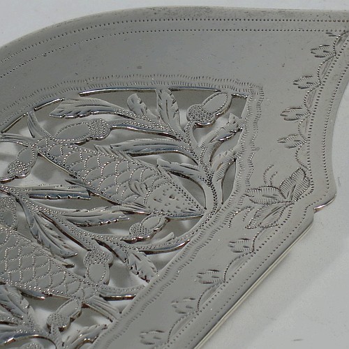 A very pretty and rare Antique Victorian Sterling Silver fish server slice, in the Fiddle pattern with an asymmetrical curved blade, having hand-engraved floral decoration together with hand-pierced fish and acorn work. Made by William Knight of London in 1845. The dimensions of this fine hand-made antique silver fish serving slice are length 30.5 cms (12 inches), and it weighs approx. 112g (3.6 troy ounces).
	   