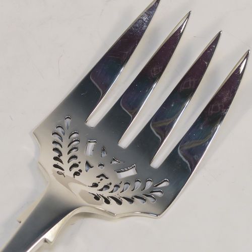 A very elegant Antique Victorian Sterling Silver fish serving fork, in the Fiddle pattern with hand-pierced floral decoration below the tines. This handsome antique silver serving fork was made by George Adams of London in 1861. The dimensions of this fine hand-made antique silver serving fork are length 25.5 cms (10 inches), and it weighs approx. 110g (3.5 troy ounces).