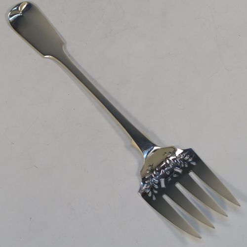 A very elegant Antique Victorian Sterling Silver fish serving fork, in the Fiddle pattern with hand-pierced floral decoration below the tines. This handsome antique silver serving fork was made by George Adams of London in 1861. The dimensions of this fine hand-made antique silver serving fork are length 25.5 cms (10 inches), and it weighs approx. 110g (3.5 troy ounces).