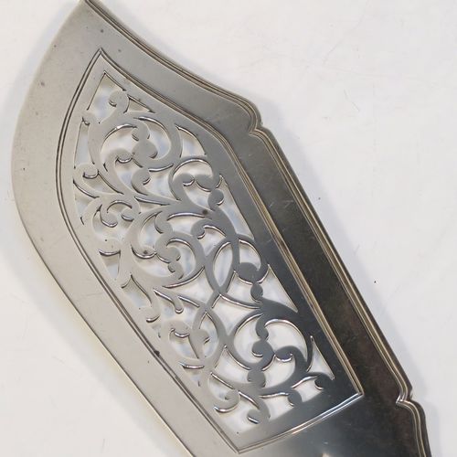 A very handsome Antique Victorian Sterling Silver fish server slice, in the Fiddle pattern, with a hand-pierced asymmetrical and curved blade. This elegant antique silver fish serving slice was made by George Adams of London in 1845. The dimensions of this fine hand-made antique silver fish server are length 32 cms (12.5 inches), and it weighs approx. 173g (5.6 troy ounces). Please note that this item is crested on the handle.