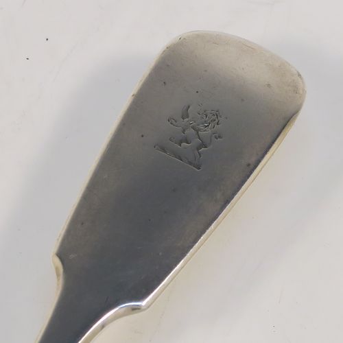 A very handsome Antique Victorian Sterling Silver fish server slice, in the Fiddle pattern, with a hand-pierced asymmetrical and curved blade. This elegant antique silver fish serving slice was made by George Adams of London in 1845. The dimensions of this fine hand-made antique silver fish server are length 32 cms (12.5 inches), and it weighs approx. 173g (5.6 troy ounces). Please note that this item is crested on the handle.