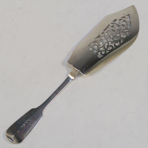 A very handsome Antique Victorian Sterling Silver fish server slice, in the Fiddle pattern, with a hand-pierced asymmetrical and curved blade. This elegant antique silver fish serving slice was made by George Adams of London in 1845. The dimensions of this fine hand-made antique silver fish server are length 32 cms (12.5 inches), and it weighs approx. 173g (5.6 troy ounces). Please note that this item is crested on the handle.