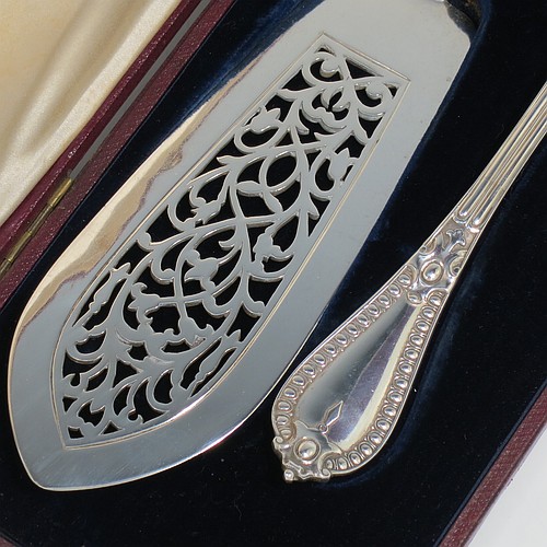 An Antique Victorian Sterling Silver pair of fish serving knife and fork set, having solid handles in the double-struck Victorian Bead pattern, with reeded handles, and hand-pierced blade and tines with floral decoration, all in their original blue velvet and cream satin lined presentation box. Made by George Adams of London in 1862. The dimensions of this fine hand-made antique silver fish serving set are length of knife 31 cms (12.75 inches), length of fork 25.5 cms (10 inches), and they weigh a total of 320g (10.3 troy ounces).   