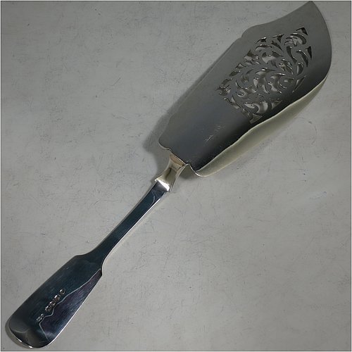 A very pretty Antique Victorian Sterling Silver fish server slice, in the Fiddle pattern with hand-engraved floral decoration on the upper side, and a hand-pierced asymmetrical and curved blade. Made by Elizabeth Eaton of London in 1846. The dimensions of this fine hand-made antique silver fish serving slice are length 32 cms (12.5 inches), and it weighs approx. 168g (5.4 troy ounces).    
