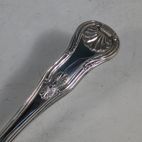 An Antique Georgian Sterling Silver fish server slice, having a double-struck Kings pattern handle, a hand-pierced asymmetrical and curved blade, and a hand-engraved reeded border. Made by William Knight of London in 1821. The dimensions of this fine hand-made antique silver fish serving slice are length 30 cms (11.75 inches), and it weighs approx. 154g (5 troy ounces).