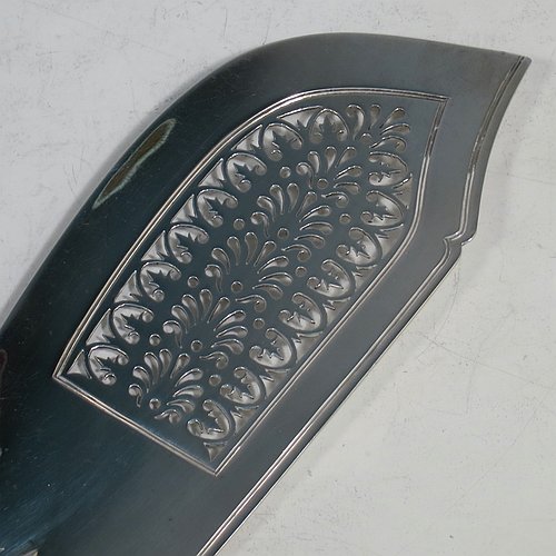 An Antique Georgian Sterling Silver fish server slice, having a double-struck Kings pattern handle, a hand-pierced asymmetrical and curved blade, and a hand-engraved reeded border. Made by William Knight of London in 1821. The dimensions of this fine hand-made antique silver fish serving slice are length 30 cms (11.75 inches), and it weighs approx. 154g (5 troy ounces).
