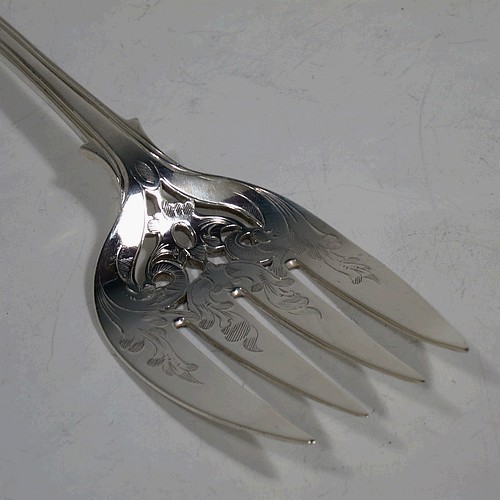 A very pretty Antique Victorian Sterling Silver fish serving knife and fork set, having handles in the double-struck Queens pattern, hand-pierced and hand-engraved with floral and leaf decoration, the blade with a cartouche engraved with a scene of a sea fishing vessel. Made by Thomas Hart Stone of Exeter in 1865. The dimensions of this fine hand-made antique silver fish serving set are length of knife 31 cms (12.25 inches), length of fork 25.5 cms (10 inches), and a total weight of 300g (9.7 troy ounces).