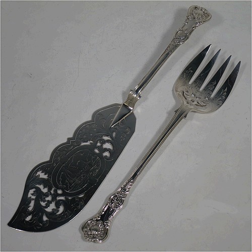 A very pretty Antique Victorian Sterling Silver fish serving knife and fork set, having handles in the double-struck Queens pattern, hand-pierced and hand-engraved with floral and leaf decoration, the blade with a cartouche engraved with a scene of a sea fishing vessel. Made by Thomas Hart Stone of Exeter in 1865. The dimensions of this fine hand-made antique silver fish serving set are length of knife 31 cms (12.25 inches), length of fork 25.5 cms (10 inches), and a total weight of 300g (9.7 troy ounces).