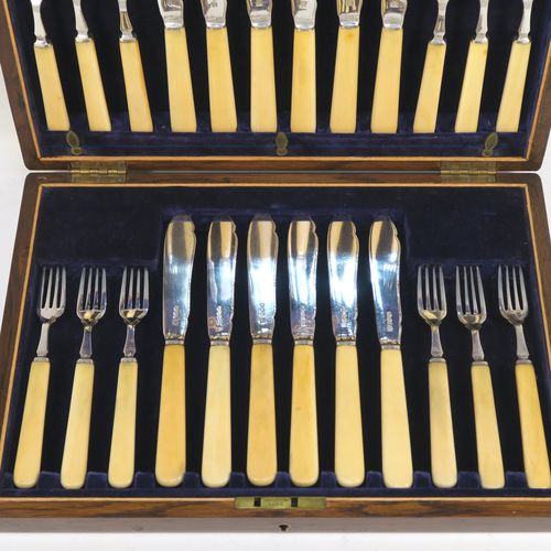 A very handsome Antique Sterling Silver and bone-handled fish set for twelve people, having hand-chased blades and tines with a pretty floral border thread, and fitted into their original dark blue velvet-lined oak presentation box. This elegant antique silver and bone-handled fish eating set was all made by Frederick Asman of Sheffield in 1921. The dimensions of these fine hand-made antique silver fish-eaters are length of knife 20 cms (8 inches), and fork 16.5 cms (6.5 inches).