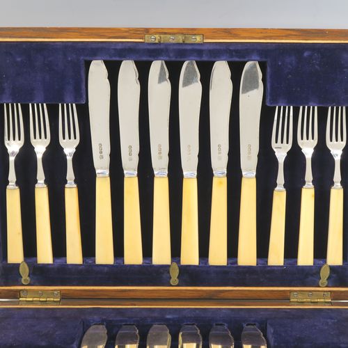 A very handsome Antique Sterling Silver and bone-handled fish set for twelve people, having hand-chased blades and tines with a pretty floral border thread, and fitted into their original dark blue velvet-lined oak presentation box. This elegant antique silver and bone-handled fish eating set was all made by Frederick Asman of Sheffield in 1921. The dimensions of these fine hand-made antique silver fish-eaters are length of knife 20 cms (8 inches), and fork 16.5 cms (6.5 inches).
