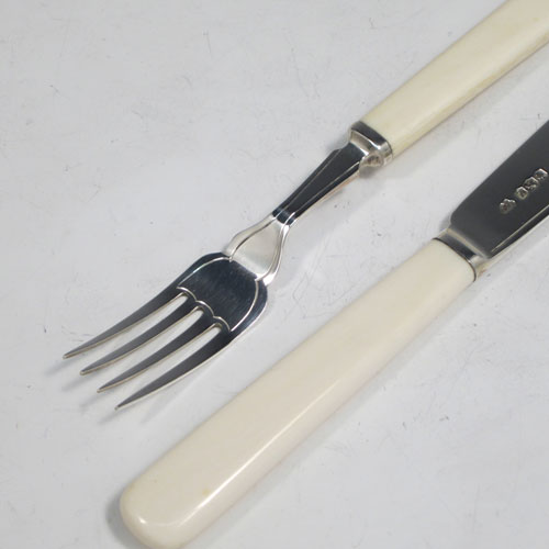 Sterling silver and bone-handled fish set for six people, having plain blades and tines with a hand-chased thread, and fitted into their original velvet and satin-lined oak presentation box. All made in Sheffield in 1942. The dimensions of these fine hand-made silver fish-eaters are length of knife 19 cms (7.5 inches), and fork 16 cms (6.25 inches).