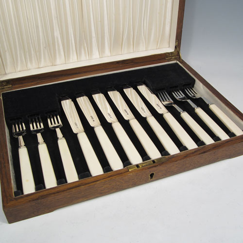 Sterling silver and bone-handled fish set for six people, having plain blades and tines with a hand-chased thread, and fitted into their original velvet and satin-lined oak presentation box. All made in Sheffield in 1942. The dimensions of these fine hand-made silver fish-eaters are length of knife 19 cms (7.5 inches), and fork 16 cms (6.25 inches).