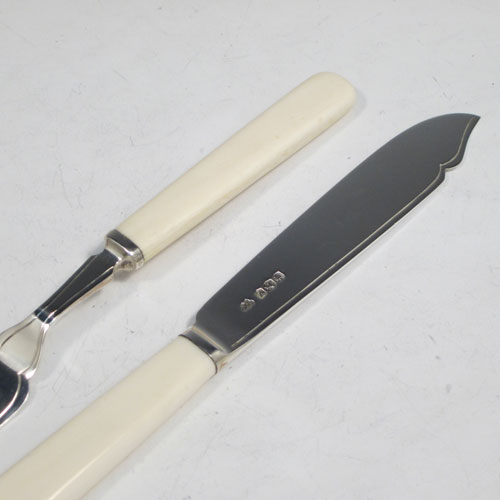 Sterling silver and bone-handled fish set for six people, having plain blades and tines with a hand-chased thread, and fitted into their original velvet and satin-lined oak presentation box. All made in Sheffield in 1942. The dimensions of these fine hand-made silver fish-eaters are length of knife 19 cms (7.5 inches), and fork 16 cms (6.25 inches).
