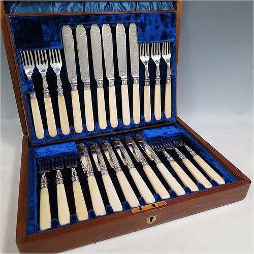 A very pretty Antique Victorian Sterling Silver and bone-handled fish set for twelve people, having hand-engraved blades and tines with floral decoration, and fitted into their original dark blue velvet and satin-lined oak presentation box. All made by Henry Atkins of Sheffield in 1896. The dimensions of these fine hand-made antique silver fish-eaters are length of knife 21.5 cms (8.5 inches), and fork 18.5 cms (7.25 inches).    