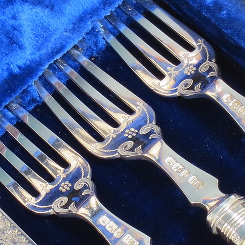 A very pretty Antique Victorian Sterling Silver and bone-handled fish set for twelve people, having hand-engraved blades and tines with floral decoration, and fitted into their original dark blue velvet and satin-lined oak presentation box. All made by Henry Atkins of Sheffield in 1896. The dimensions of these fine hand-made antique silver fish-eaters are length of knife 21.5 cms (8.5 inches), and fork 18.5 cms (7.25 inches).    