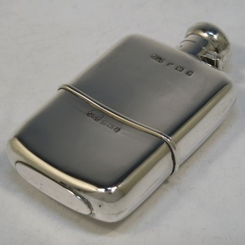 A very handsome Antique Edwardian Sterling Silver whisky hip flask, having a plain shaped rectangular body with rounded shoulders, a bayonet-fit lid, and a pull-off cup. Made by Marks and Cohen of Birmingham in 1905. The dimensions of this fine hand-made antique silver whisky flask are length 11.5 cms (4.5 inches), width 6 cms (2.3 inches), depth 2 cms (0.75 inch), and it weighs approx. 135g (4.4 troy ounces).