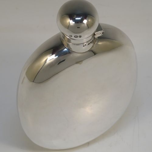 A very large and handsome Antique Victorian Sterling Silver whisky hip flask, having a plain oval body, and a round bayonet-fit lid. This elegant silver whisky flask was made by William Hutton and Sons of London in 1895. The dimensions of this fine hand-made antique silver flask are length 18.5 cms (7.25 inches), width 11 cms (4.25 inches), and it weighs approx. 261g (8.4 troy ounces).   