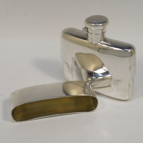A heavy and very handsome Antique Sterling Silver whisky hip flask, having a plain shaped rectangular body with rounded shoulders, a bayonet-fit lid, and a pull-off cup with gold-gilt interior. This elegant antique silver whisky flask and cup were made by Deakin and Francis of Birmingham in 1917. The dimensions of this fine hand-made antique silver whisky flask are length 12 cms (4.75 inches), width 12 cms (4.75 inches), depth 4 cms (1.5 inches), and it weighs approx. 272g (8.8 troy ounces).