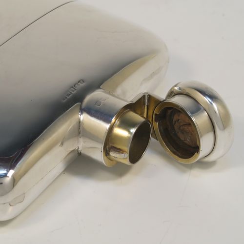 A heavy and very handsome Antique Sterling Silver whisky hip flask, having a plain shaped rectangular body with rounded shoulders, a bayonet-fit lid, and a pull-off cup with gold-gilt interior. This elegant antique silver whisky flask and cup were made by Deakin and Francis of Birmingham in 1917. The dimensions of this fine hand-made antique silver whisky flask are length 12 cms (4.75 inches), width 12 cms (4.75 inches), depth 4 cms (1.5 inches), and it weighs approx. 272g (8.8 troy ounces).