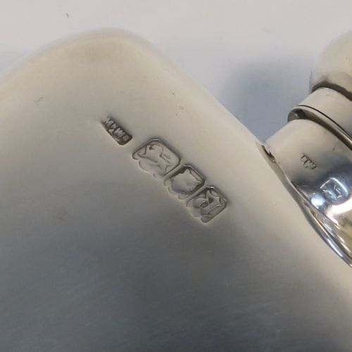 A very handsome Antique Sterling Silver whisky hip flask, having a plain shaped rectangular body with rounded shoulders, and a round hinged bayonet-fit lid. This elegant antique silver whisky flask was made by Mappin and Webb of London in 1918. The dimensions of this fine hand-made antique silver hip whisky flask are length 13.5 cms (5.3 inches), width 7.5 cms (3 inches), depth 2.5 cms (1 inch), and it weighs approx. 124g (4 troy ounces).
